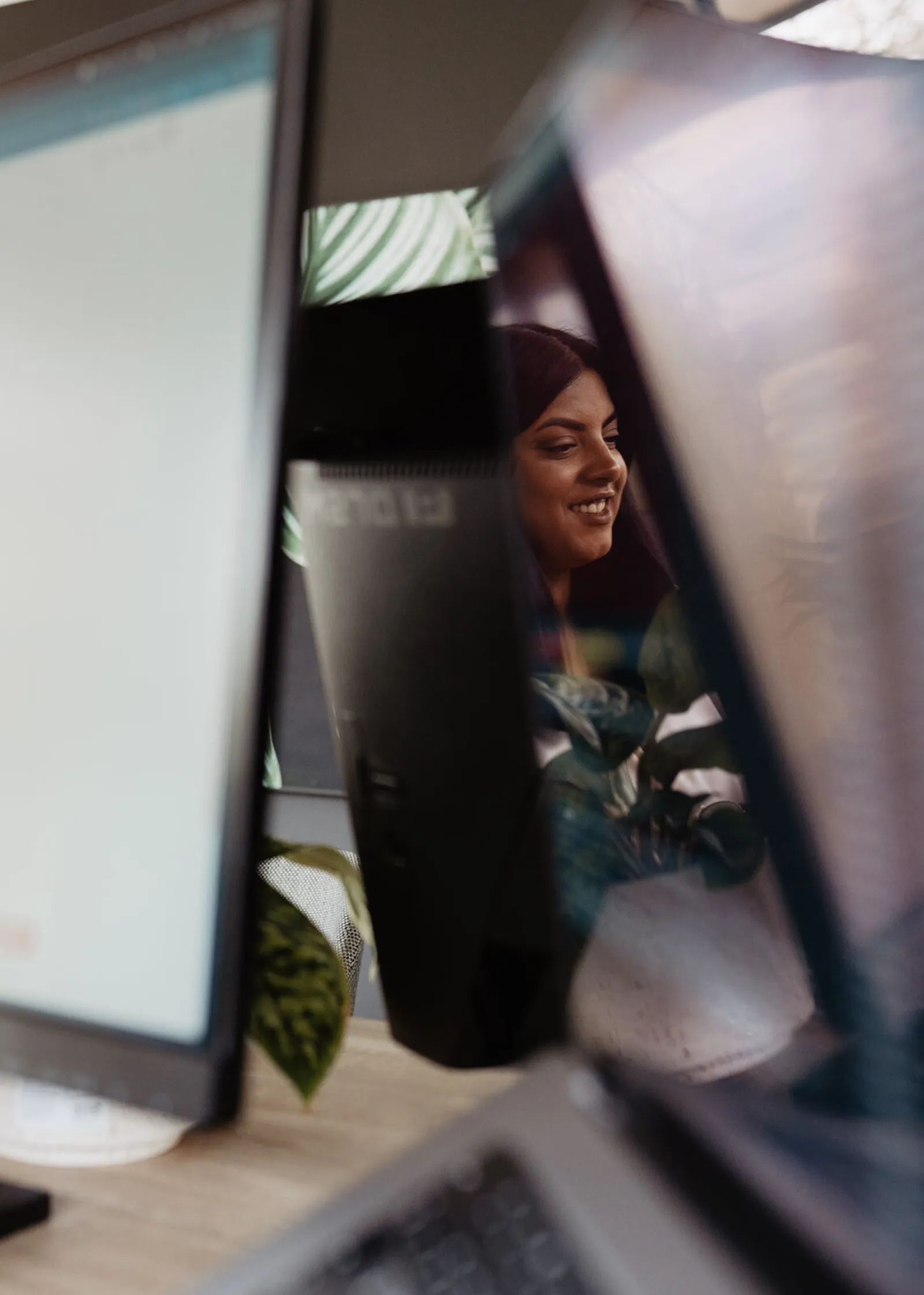 Developer van Coding.nl aan het werk, gespiegeld in de monitor